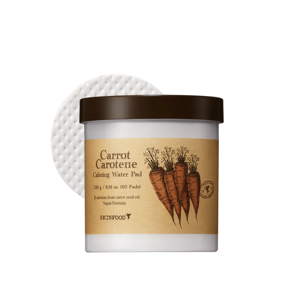 Purkki "Carrot Carotene Calming Water Pad" SKINFOOD. Purkissa on 60 tyynyä ja se on merkitty porkkanakuvalla. Tuote, joka perustuu porkkanansiemenöljyyn, on vegaaniystävällinen ja suunniteltu rauhoittamaan ihoa.