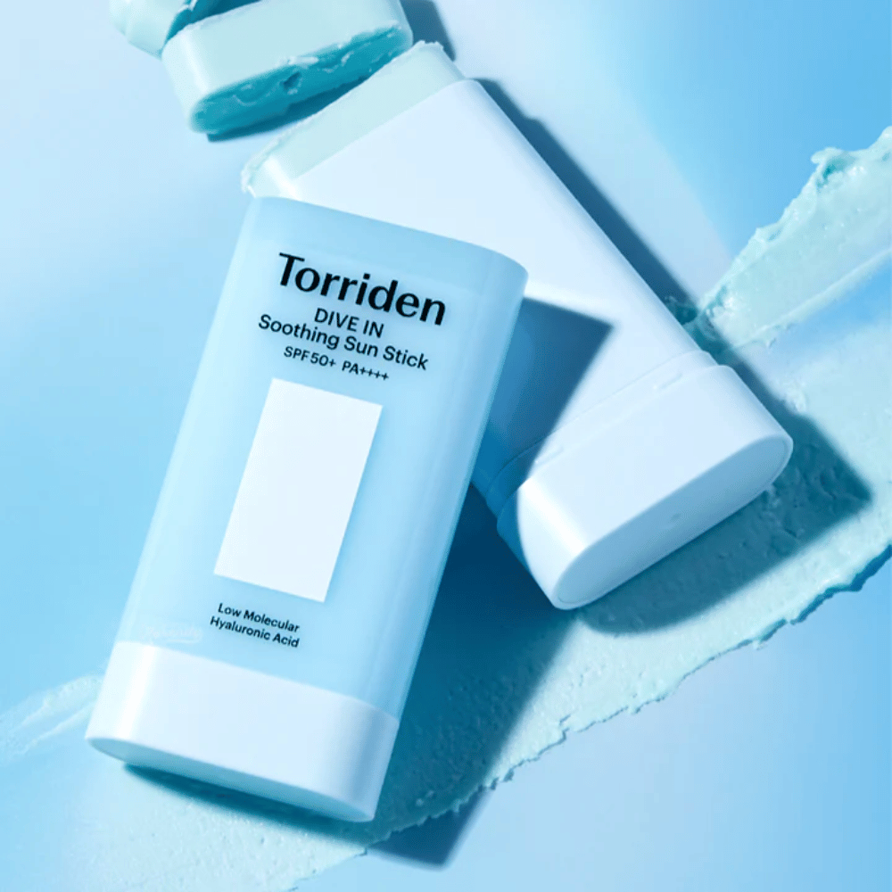 Torriden DIVE IN Soothing Sun Stick SPF50+ PA++++ yhdessä levitetyn tuotetekstuurin kanssa, joka havainnollistaa kosteuttavaa ja kevyttä levitystä.