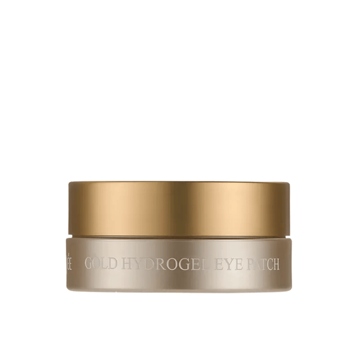 Vapaataustainen tuotekuva tuotteesta PETITFEE Gold Hydrogel Eye Patch elegantissa kullanvärisessä purkissa vaaleaa taustaa vasten. Muotoilu antaa eksklusiivisen ja ylellisen vaikutelman.