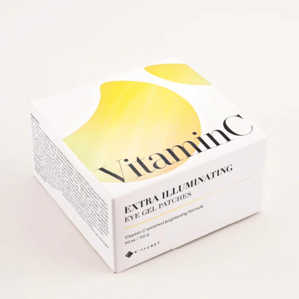 Pakkaus, jossa on K-Secret Extra Illuminating Eye Gel Patches, jossa on C-vitamiinia, valkoisella ja keltaisella designilla.