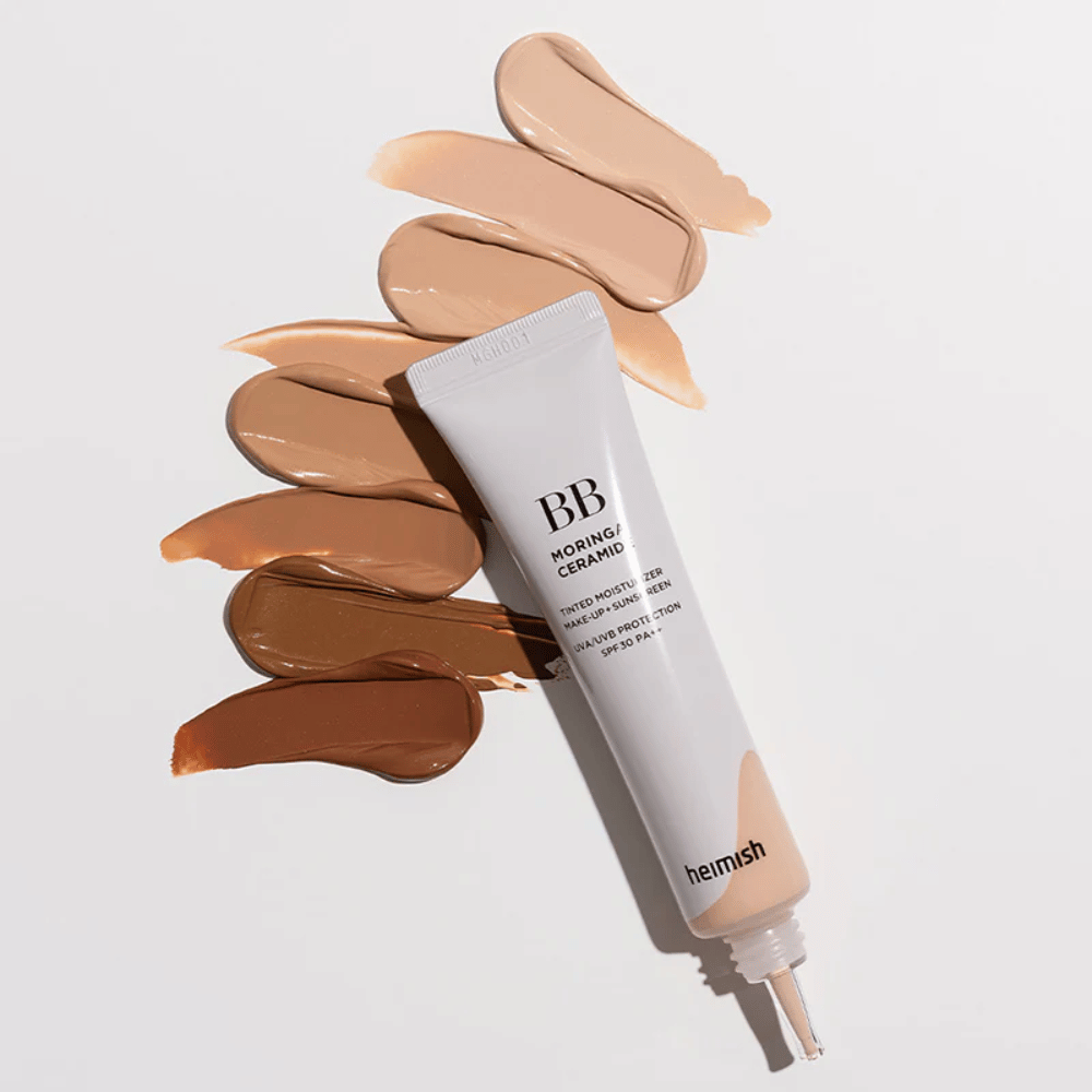 Heimish Moringa Ceramide BB Cream useiden eri ihonsävyisten sävynäytteiden ympäröimänä. Kuva esittelee tuotteen laajan värivalikoiman ja kermaisen koostumuksen, joka antaa luonnollisen peittävyyden ja tasaisen ihonsävyn.