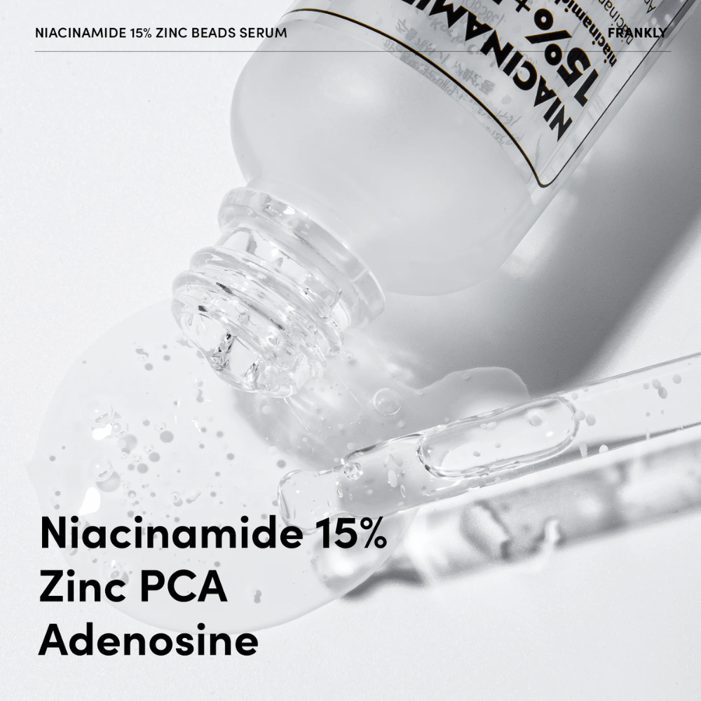 Lähikuva FRANKLY Niacinamide 15% + Zinc Beads Serumista, jota kaadetaan ulos. Teksti näyttää ainesosat: Niacinamide 15 %, Zinc PCA ja Adenosine.