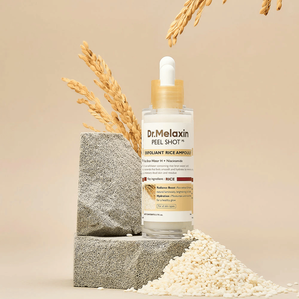 Dr.Melaxin Peel Shot Exfoliant Rice Ampoule asetettuna riisin ja kivien kanssa, korealainen kuoriva ampulli riisiuutteella ja niasiiniamidilla kirkkaamman ja pehmeämmän ihon saavuttamiseksi.
