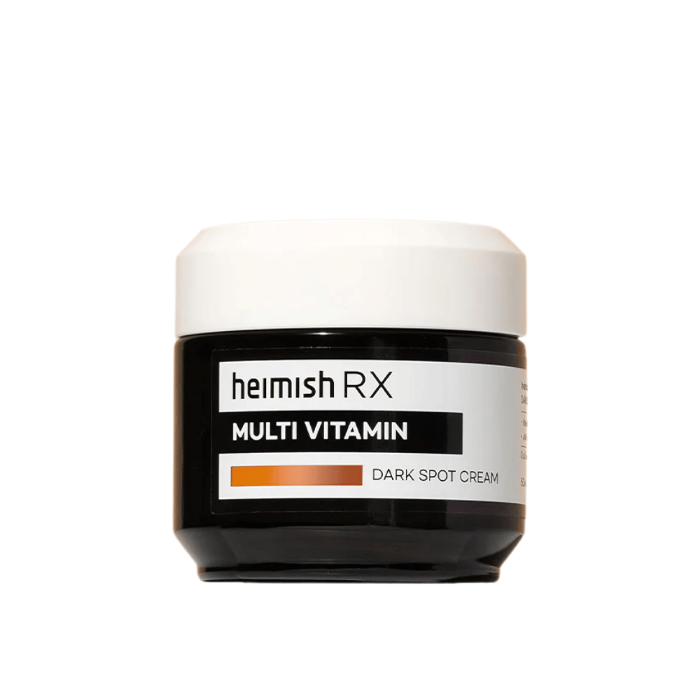 Heimish RX Multi Vitamin Dark Spot Cream tyylikkäässä mustassa purkissa, jossa on valkoinen kansi. Kasvovoide, joka on rikastettu monivitamiineilla, suunniteltu vähentämään tummia läiskiä ja tasoittamaan ihon sävyä.