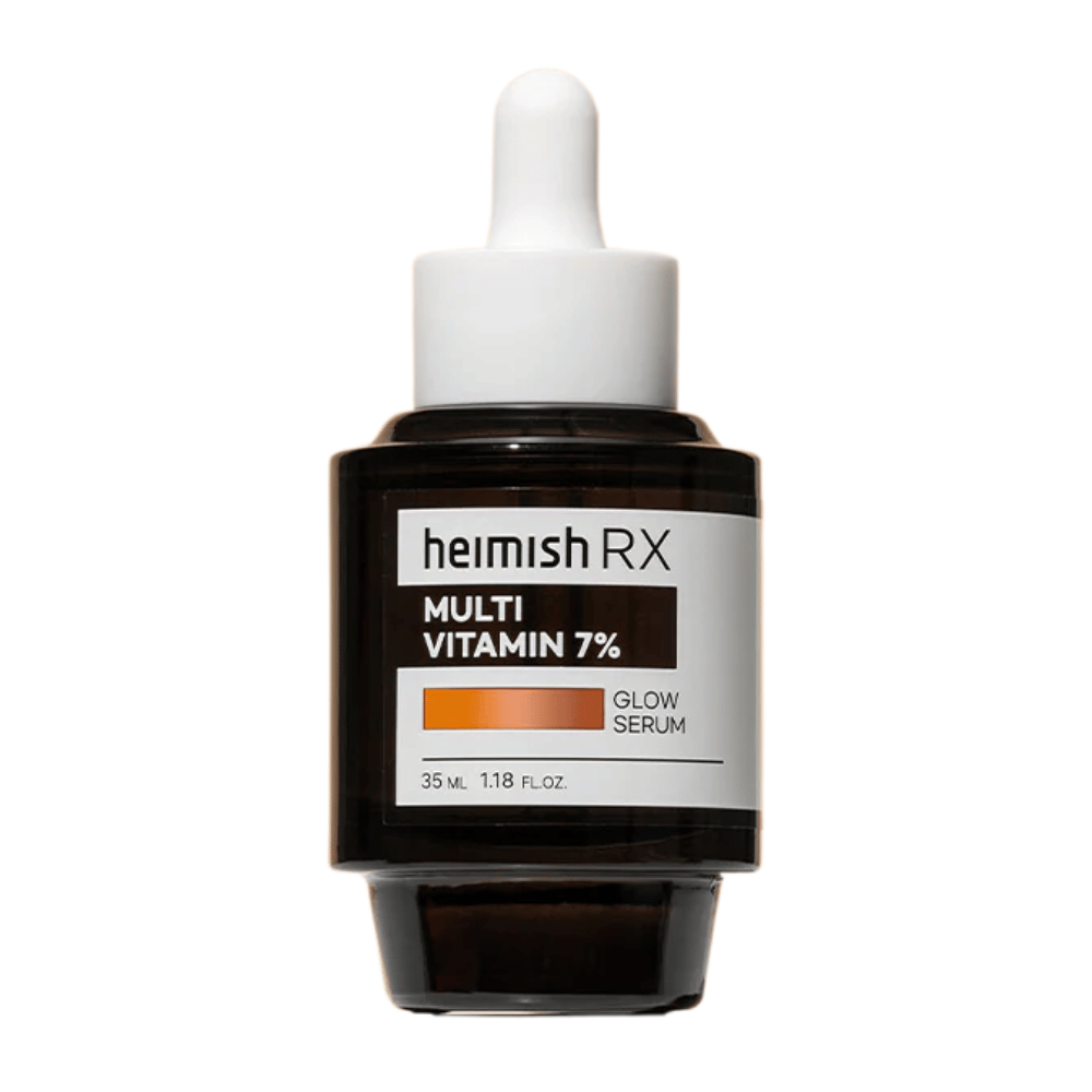 Heimish RX Multi Vitamin 7% Glow Serum tummassa lasipullossa pipettikorkilla, suunniteltu antamaan hehkua ja ravintoa iholle.