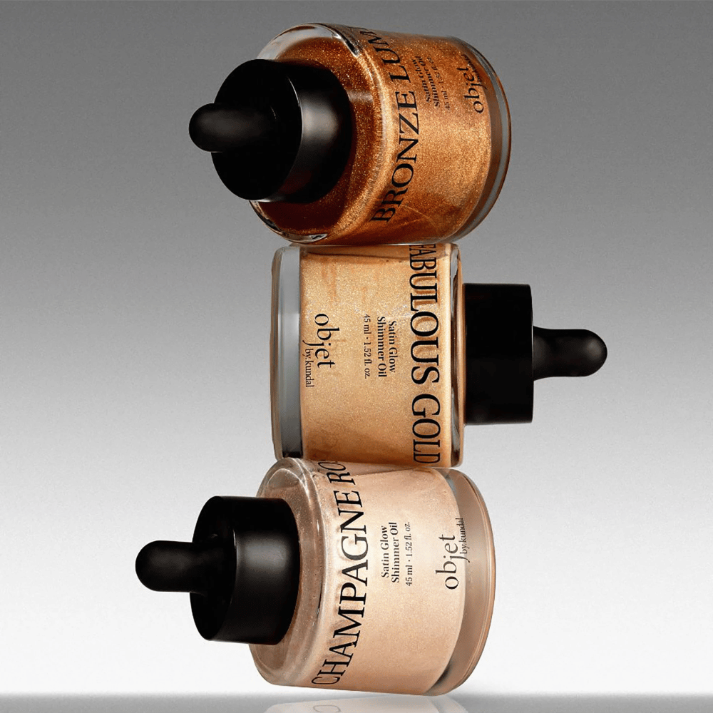 Objet by KUNDAL Satin Glow Shimmer Oil sävyissä Bronze Lumière, Fabulous Gold ja Champagne Rose – hohtavat vartaloöljyt hehkua antavalla viimeistelyllä.