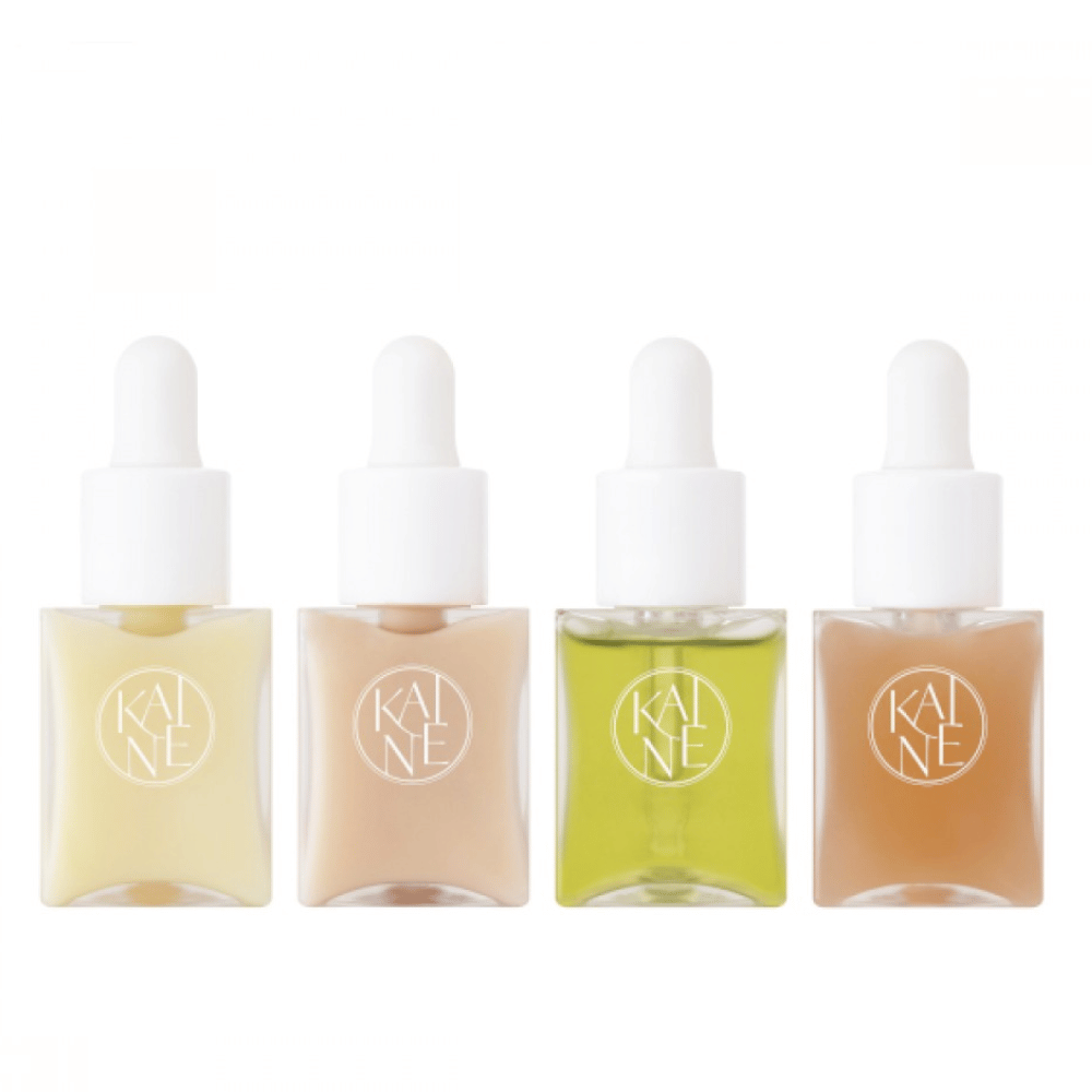 Neljä värikästä seerumipulloa KAINÉ Serum Discovery Kit pipettikorkilla, suunniteltu vastaamaan erilaisiin ihon tarpeisiin minimalistisessa ja tyylikkäässä pakkauksessa.