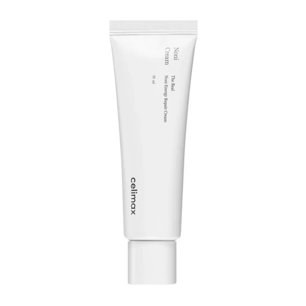Celimax Noni Energy Repair Cream valkoisessa tuubissa mustalla tekstillä. Tuote on merkitty "The Real Noni Energy Repair Cream" ja sen tilavuus on 50 ml.